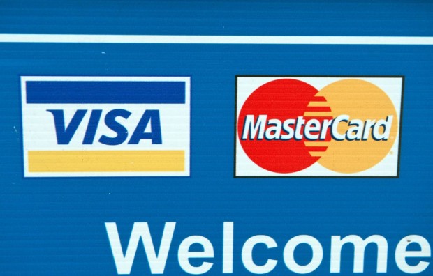 Visa and MasterCard credit card logos are seen on a sign in Washington on March 30, 2012. 