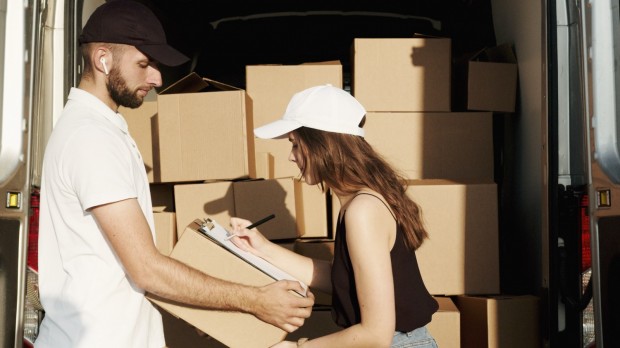 Woman Receiving the Package from the Deliveryman