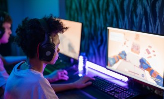Boy with Black Headphones Playing Computer Game