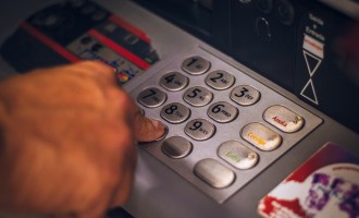 Using an ATM - Hand pressing number