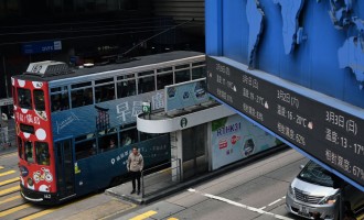 A tram passes by in the Central business district of Hong Kong 