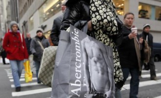 Shoppers carry bags as they walk down Fifth Avenue in New York