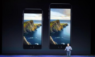 Phil Schiller, Senior Vice President at Apple Inc., speaks about the iPhone 6 (L) and the iPhone 6 Plus