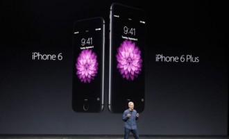 Apple CEO Tim Cook introduces the new iPhone 6 and iPhone 6 Plus (R) during an Apple event at the Flint Center in Cupertino, California, September 9, 2014. 