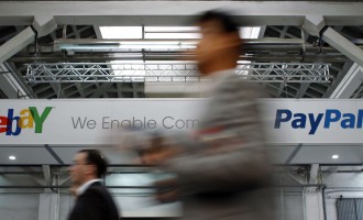 Visitors walk past an Ebay and PayPal banner at the Mobile World Congress in Barcelona in this February 28, 2012, file photo.  Bill Me Later, one of eBay's fastest-growing businesses, offers credit to online shoppers, letting them pay typically a few mont