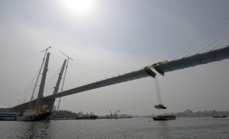 The final section is installed to complete the bridge across the Golden Horn bay in Vladivostok April 14, 2012. The bridge is part of a series of large infrastructure projects the city is undertaking for the 2012 Asia-Pacific Economic Cooperation (APEC) s