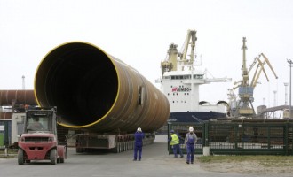 GERMANY, Rostock, Giant pipes made by EEW Special Pipe Constructions GmbH in Rostock for the offshore wind farm Walney 2 in the northern North Sea, The pipes are being taken to the transport ship from the EEW grounds.