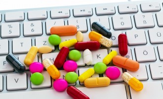 Symbolic photo online pharmacy, pills on a computer keyboard